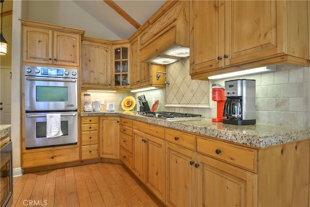 173 Grizzly Rd, Lake Arrowhead, CA 92352 - kitchen featuring stainless steel appliances, vaulted ceiling, light wood-style floors, light stone counters, and tasteful backsplash
