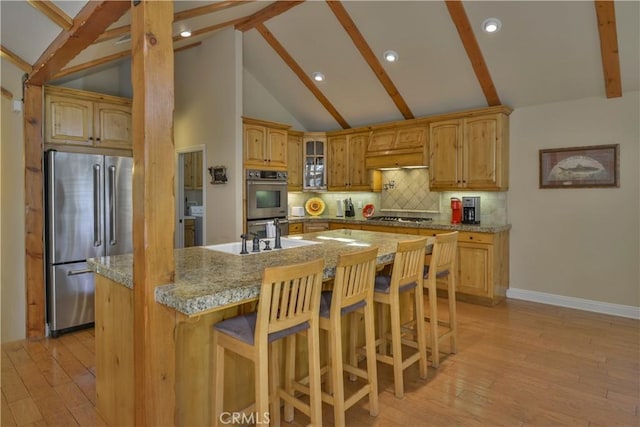 173 Grizzly Rd, Lake Arrowhead, CA 92352 - kitchen featuring appliances with stainless steel finishes, light wood finished floors, backsplash, a kitchen bar, and glass insert cabinets