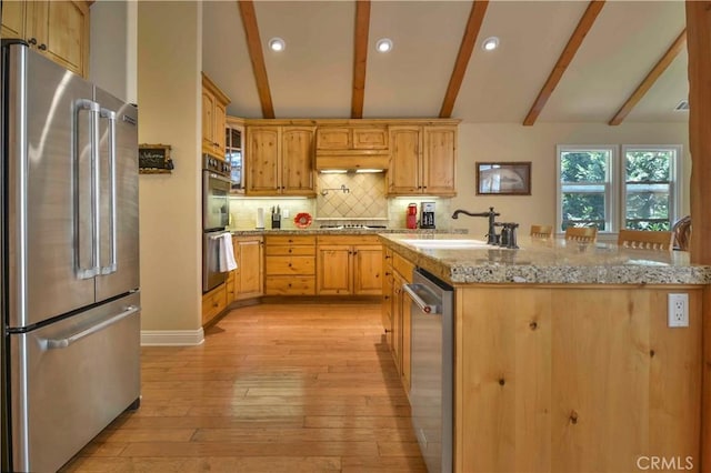173 Grizzly Rd, Lake Arrowhead, CA 92352 - kitchen with stainless steel appliances, light wood-style flooring, decorative backsplash, recessed lighting, and light stone countertops