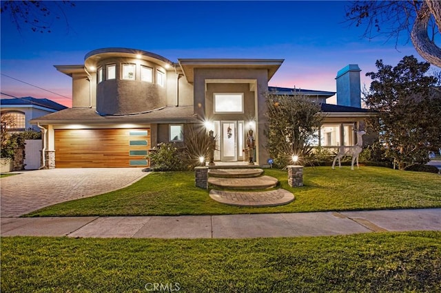 view of front of house with a lawn and a garage