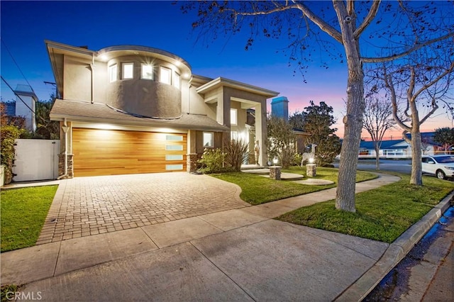 view of front of property with a yard and a garage