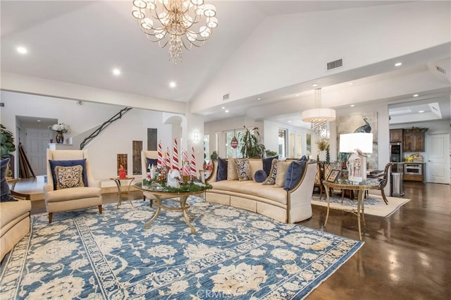 living room with high vaulted ceiling and a notable chandelier