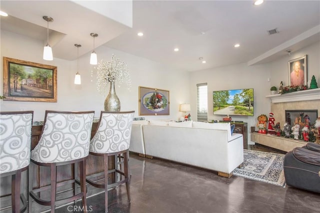 living room with a tiled fireplace