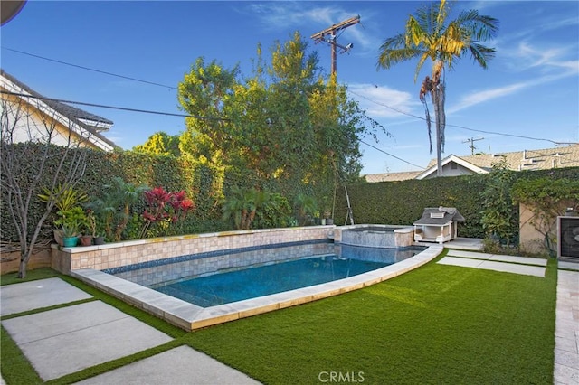 view of pool with a yard and grilling area