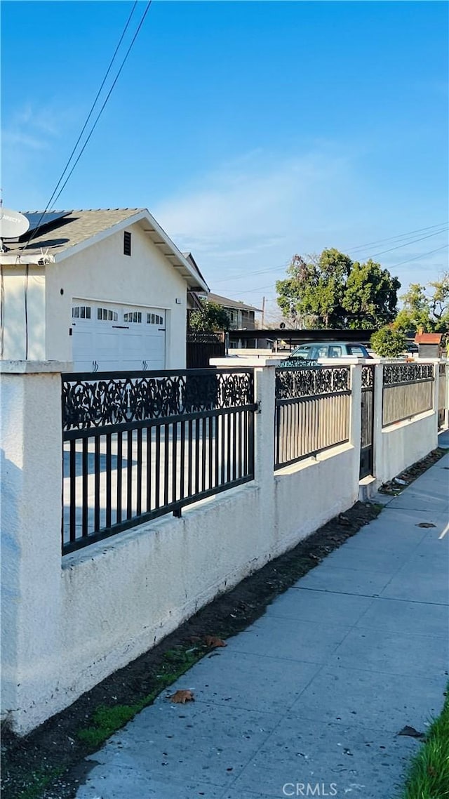 view of gate with a garage