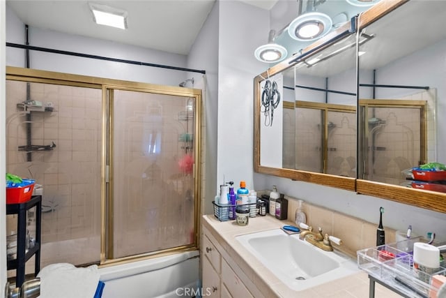 bathroom with vanity and enclosed tub / shower combo