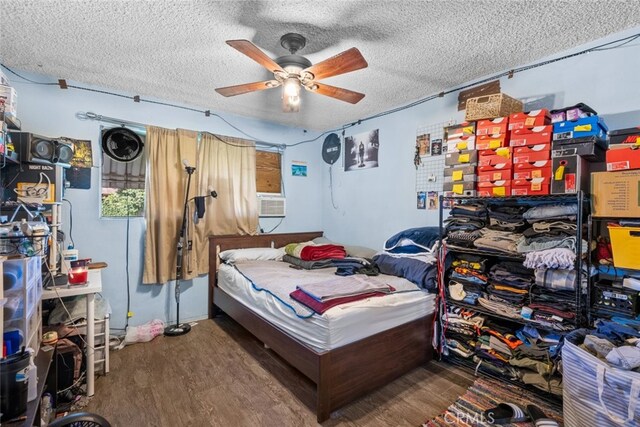 bedroom featuring ceiling fan, a textured ceiling, and hardwood / wood-style flooring