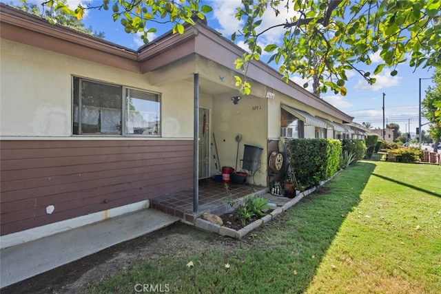 view of side of home featuring a lawn