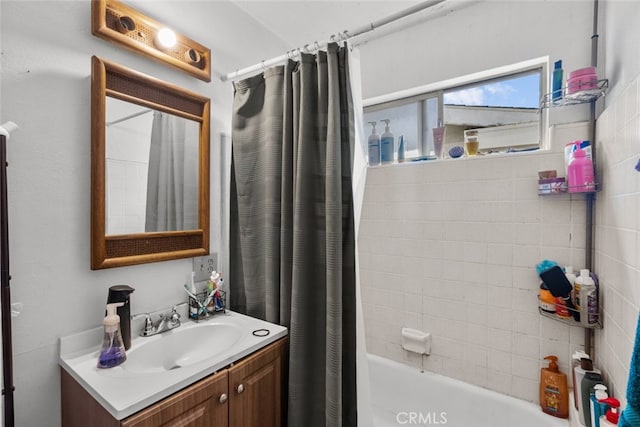 bathroom featuring shower / tub combo and vanity