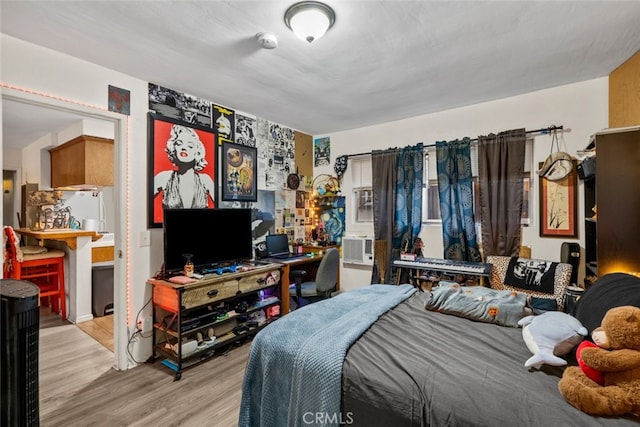 bedroom featuring light wood-type flooring and cooling unit