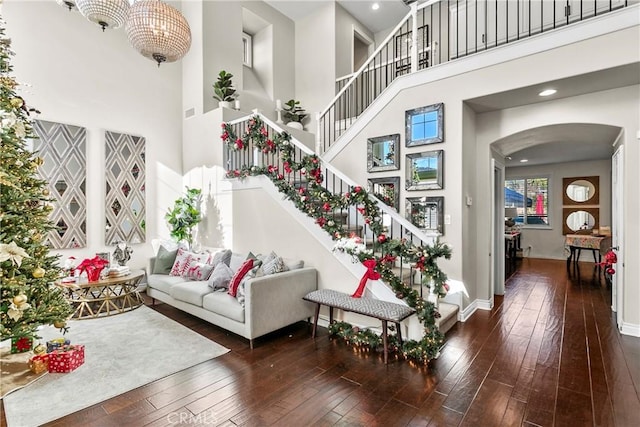 living room with dark hardwood / wood-style floors and a high ceiling