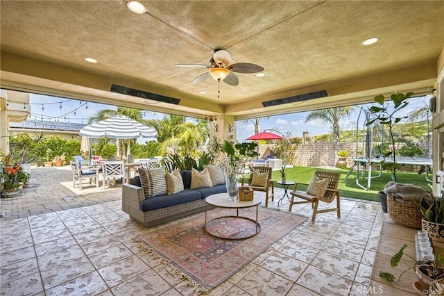 view of patio / terrace with a trampoline, outdoor lounge area, and ceiling fan