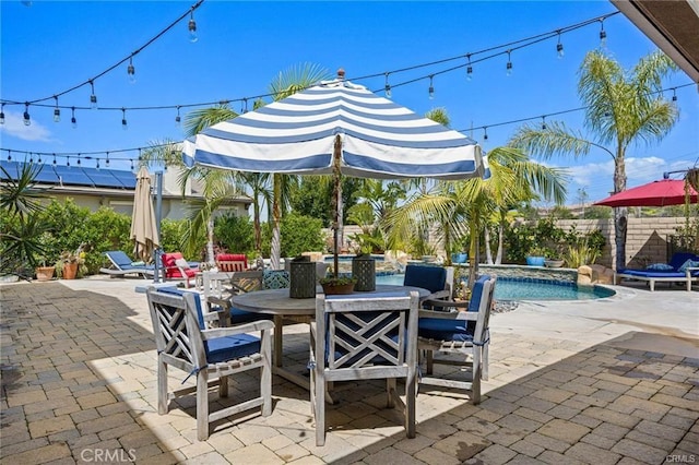 view of patio / terrace featuring a pool with hot tub