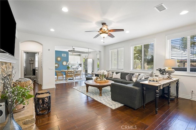 living room with ceiling fan and dark hardwood / wood-style floors