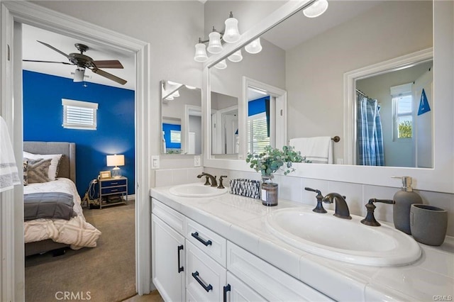 bathroom with vanity, ceiling fan, and a shower with curtain