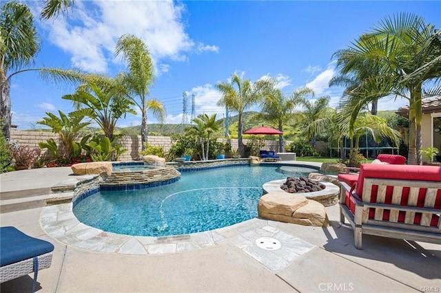 view of pool with a patio area and an in ground hot tub