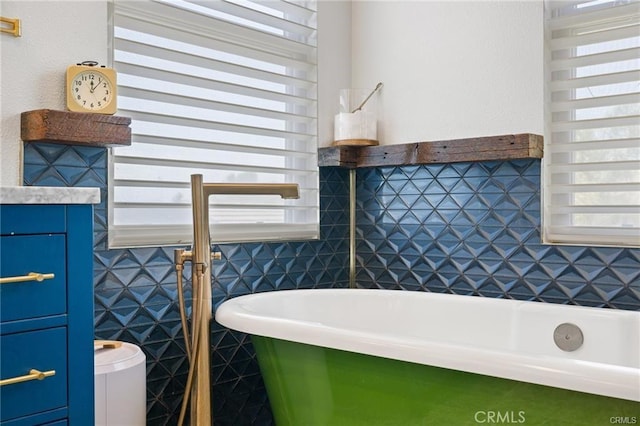 bathroom featuring tile walls and a bath