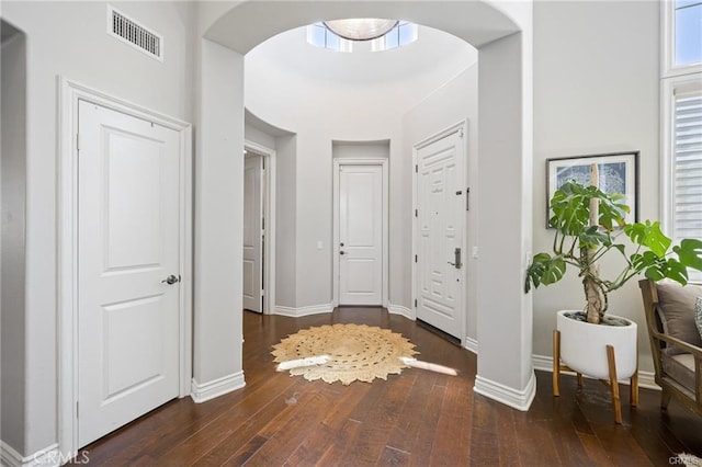 corridor with dark hardwood / wood-style flooring