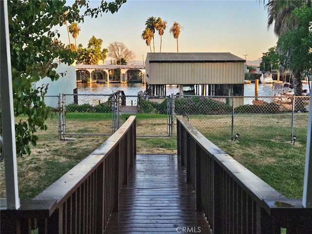 view of community with a water view and a yard