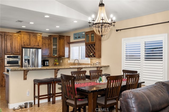 dining space featuring an inviting chandelier, light tile patterned flooring, visible vents, and recessed lighting