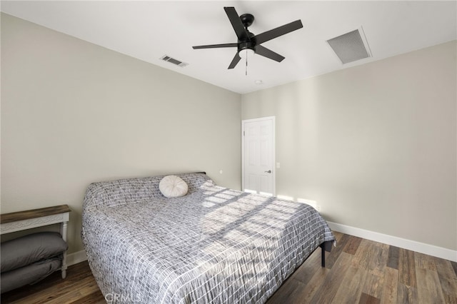 bedroom featuring baseboards, visible vents, and wood finished floors