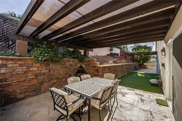 view of patio / terrace featuring fence and outdoor dining area