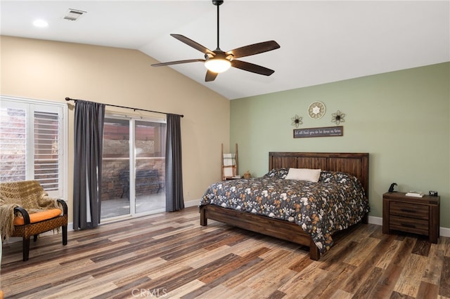 bedroom with visible vents, vaulted ceiling, baseboards, and wood finished floors