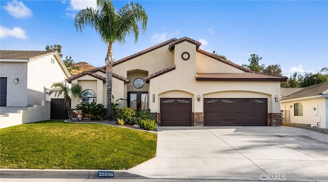 view of front of home with a garage, driveway, a front lawn, and stucco siding