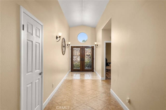 doorway to outside featuring lofted ceiling, french doors, baseboards, and light tile patterned floors