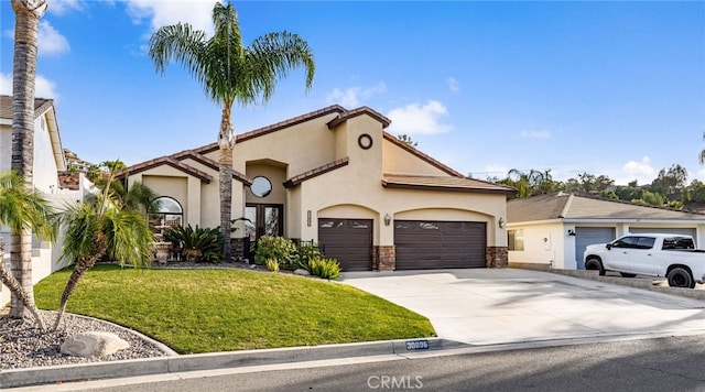 mediterranean / spanish-style house featuring an attached garage, a front lawn, concrete driveway, and stucco siding