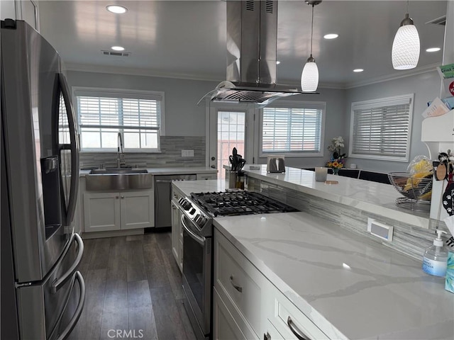 kitchen featuring white cabinetry, island exhaust hood, stainless steel appliances, light stone countertops, and pendant lighting