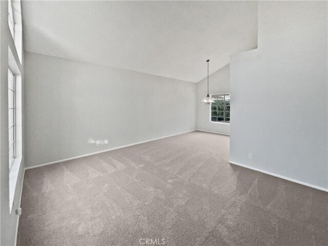 interior space featuring a wealth of natural light, lofted ceiling, and carpet floors