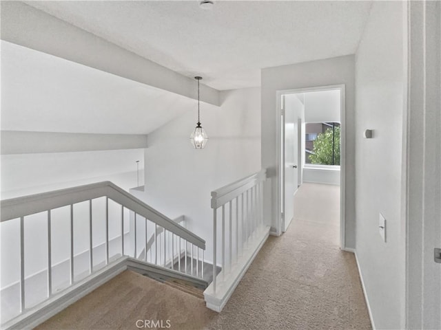 hallway featuring carpet and vaulted ceiling with beams