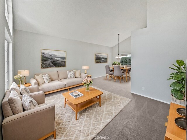 carpeted living room with lofted ceiling and a healthy amount of sunlight