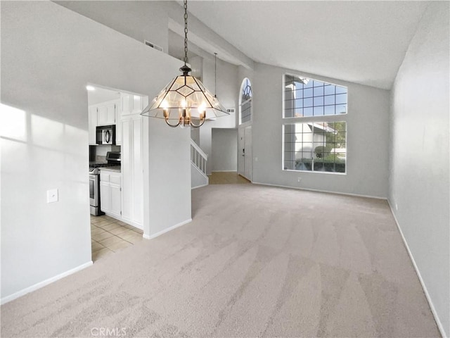 unfurnished dining area featuring light carpet, a chandelier, and high vaulted ceiling