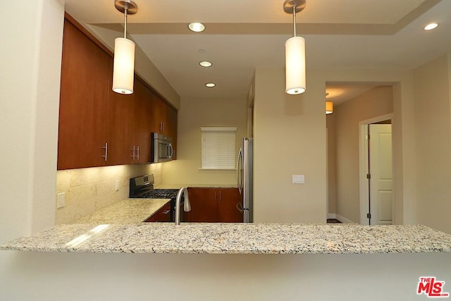 kitchen with stainless steel appliances, tasteful backsplash, hanging light fixtures, kitchen peninsula, and light stone counters