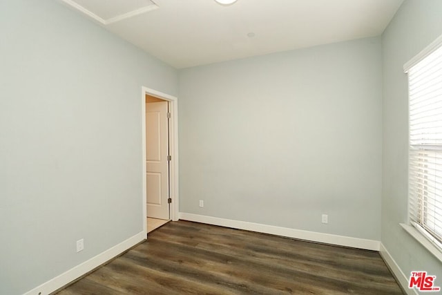 unfurnished room featuring dark hardwood / wood-style flooring