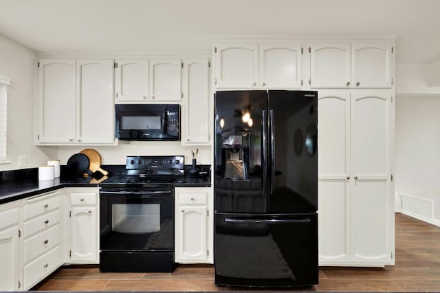 kitchen featuring white cabinetry and black appliances