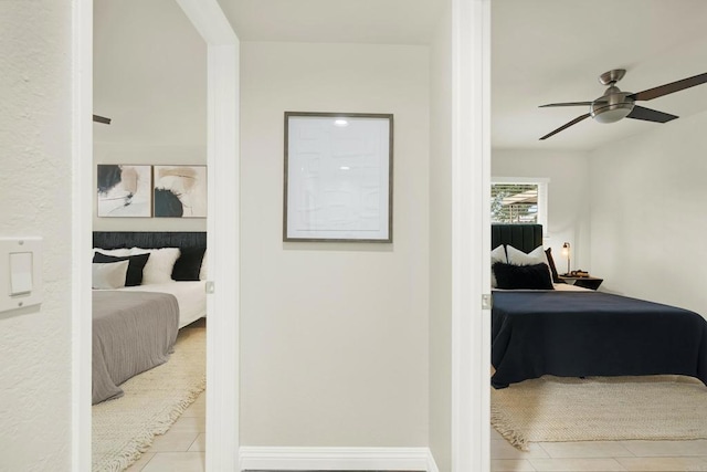 tiled bedroom featuring ceiling fan