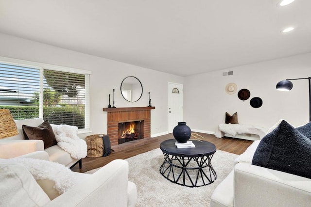 living room with hardwood / wood-style floors and a fireplace