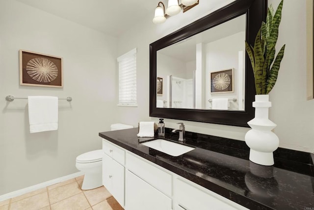 bathroom with vanity, tile patterned floors, and toilet