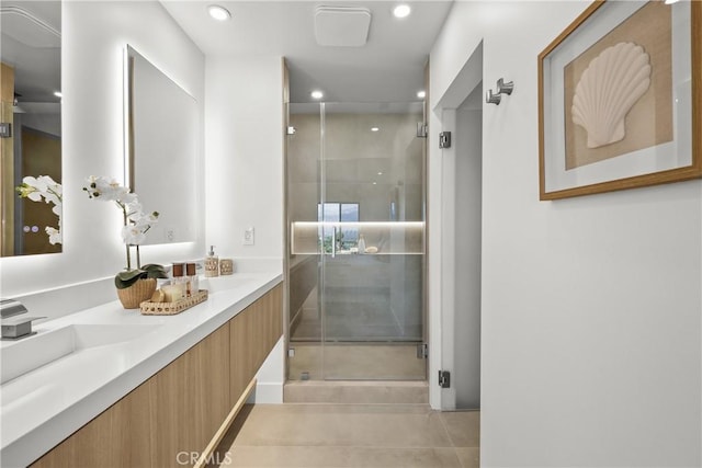 bathroom featuring vanity, tile patterned floors, and walk in shower