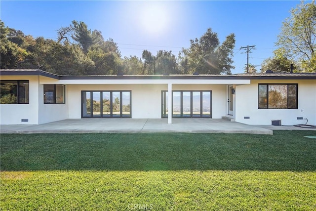 back of property featuring a yard and a patio