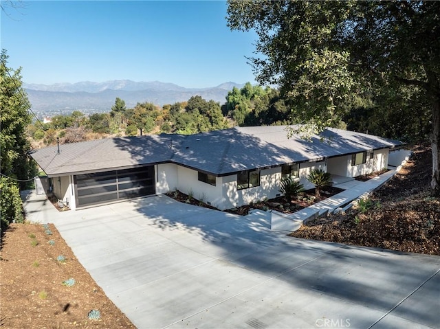 view of front facade with a garage and a mountain view