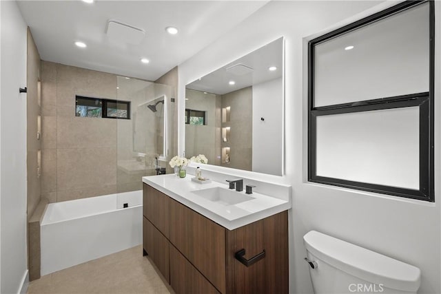 full bathroom featuring vanity, toilet, and tiled shower / bath combo