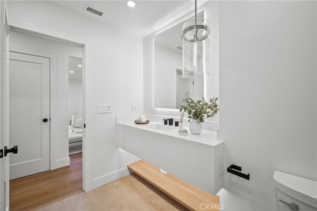 bathroom with vanity, toilet, and tile patterned flooring