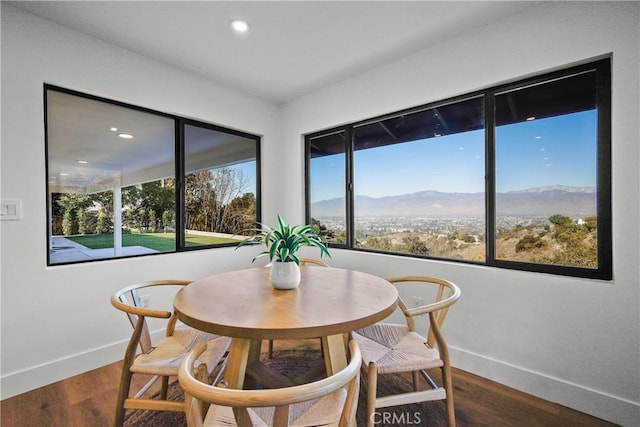 dining space featuring dark hardwood / wood-style flooring and a mountain view