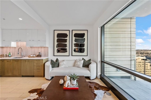 living room with sink, a wealth of natural light, and light hardwood / wood-style flooring