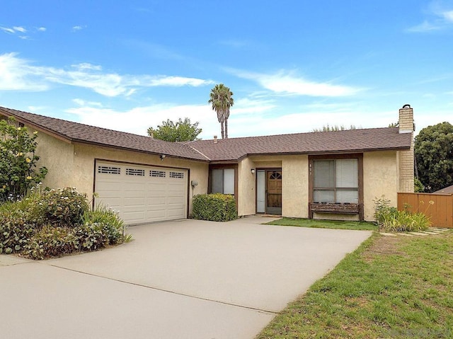 ranch-style house featuring a front lawn and a garage