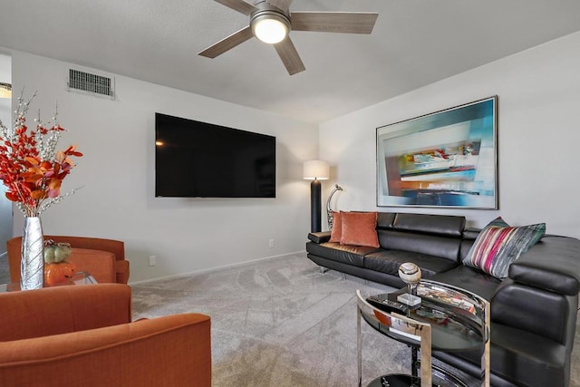 carpeted living room featuring ceiling fan